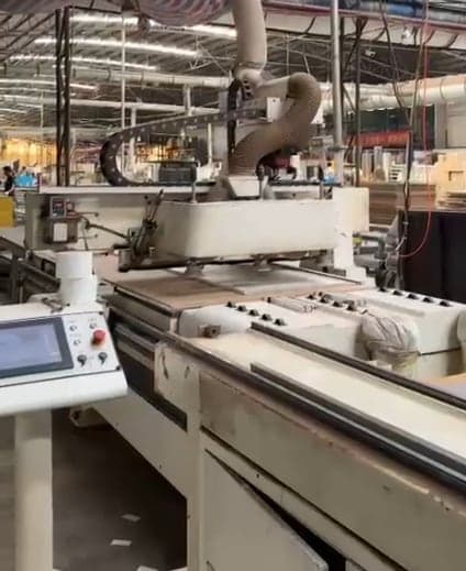 A CNC machine preparing cabinet parts